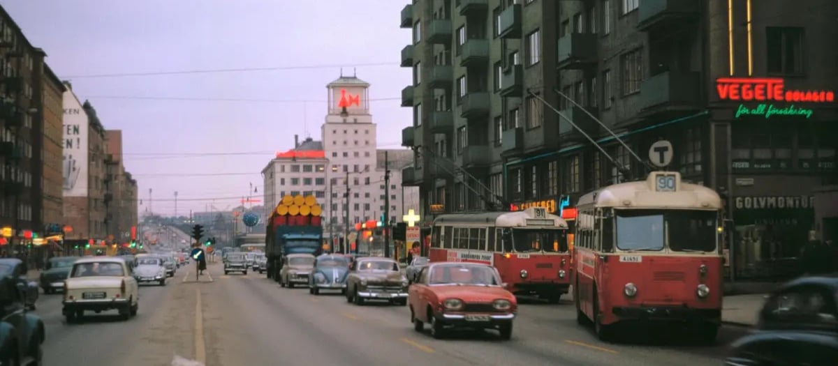 En stadsgata med tät trafik intill höga byggnader.