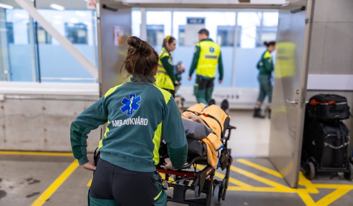 En kvinna som skjuter en vagn full med bagage.