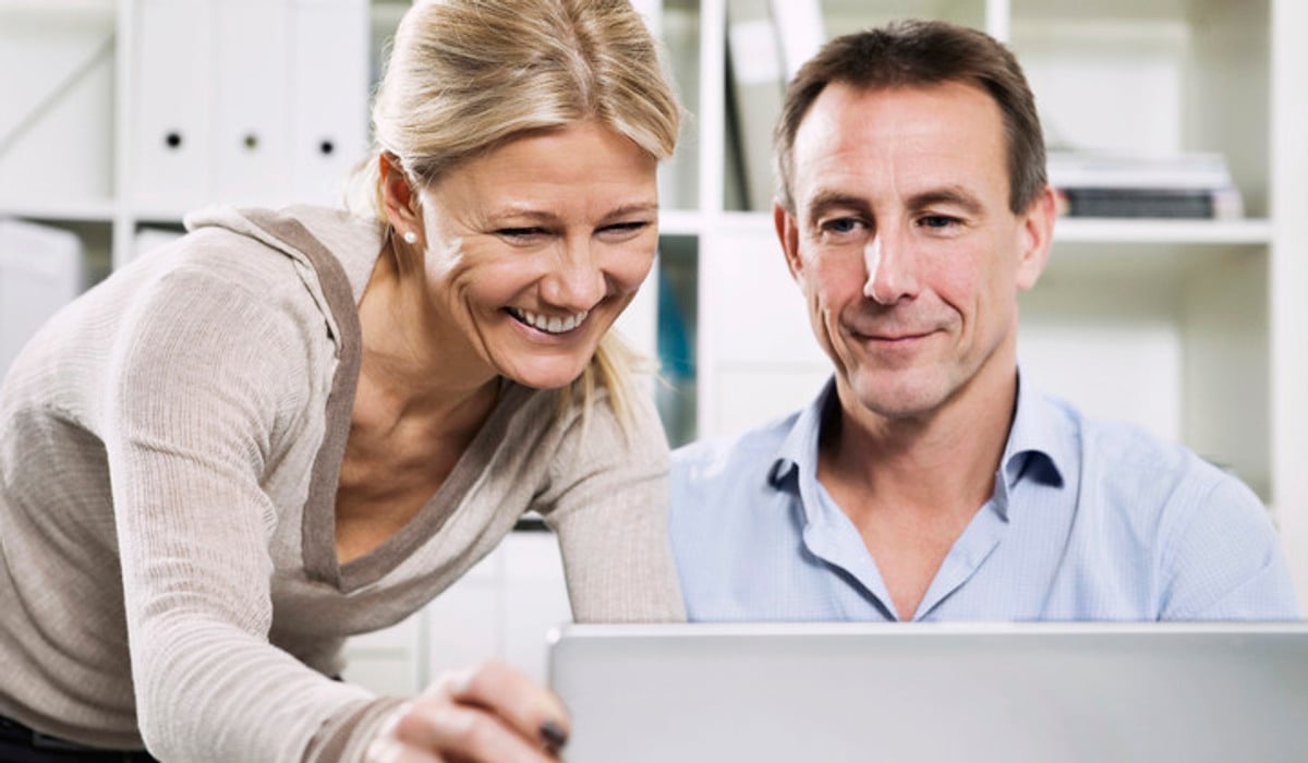 En man och en kvinna tittar tillsammans på en datorskärm.