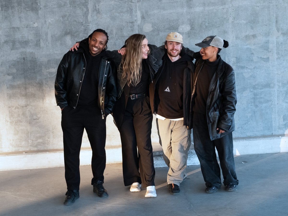 Fyra personer med armarna om varandras axlar