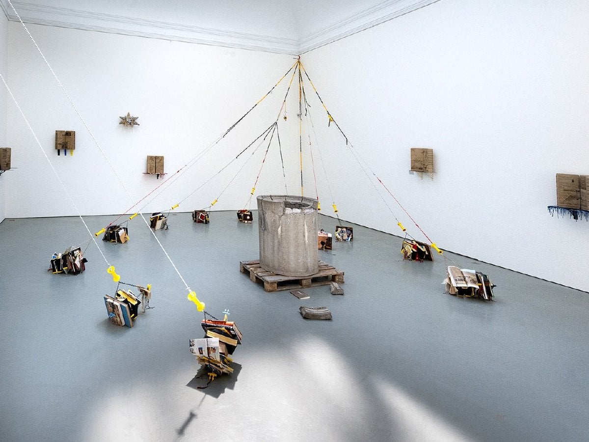 Rum med en installation. Små objekt sammanbundna med rep.