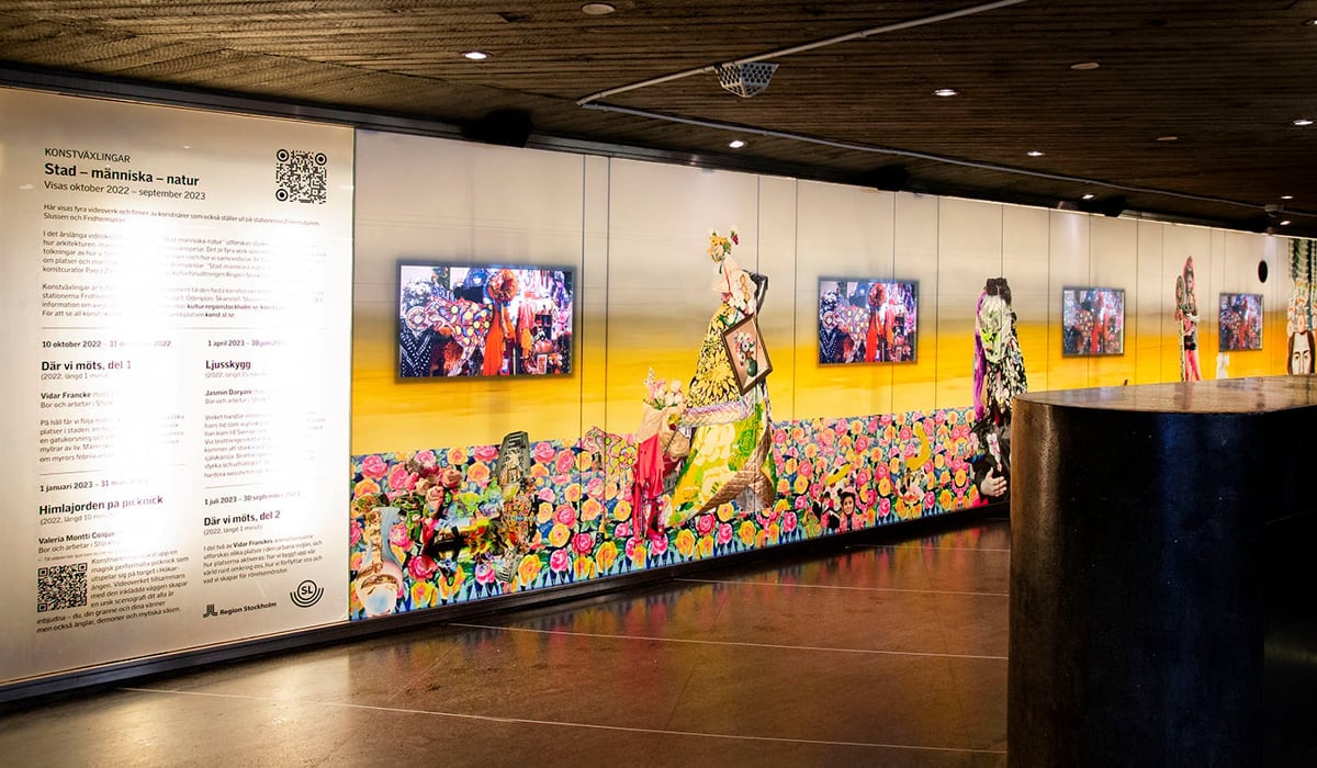Stationsvägg vid Skanstull där det visas videokonst på fyra skärmar.