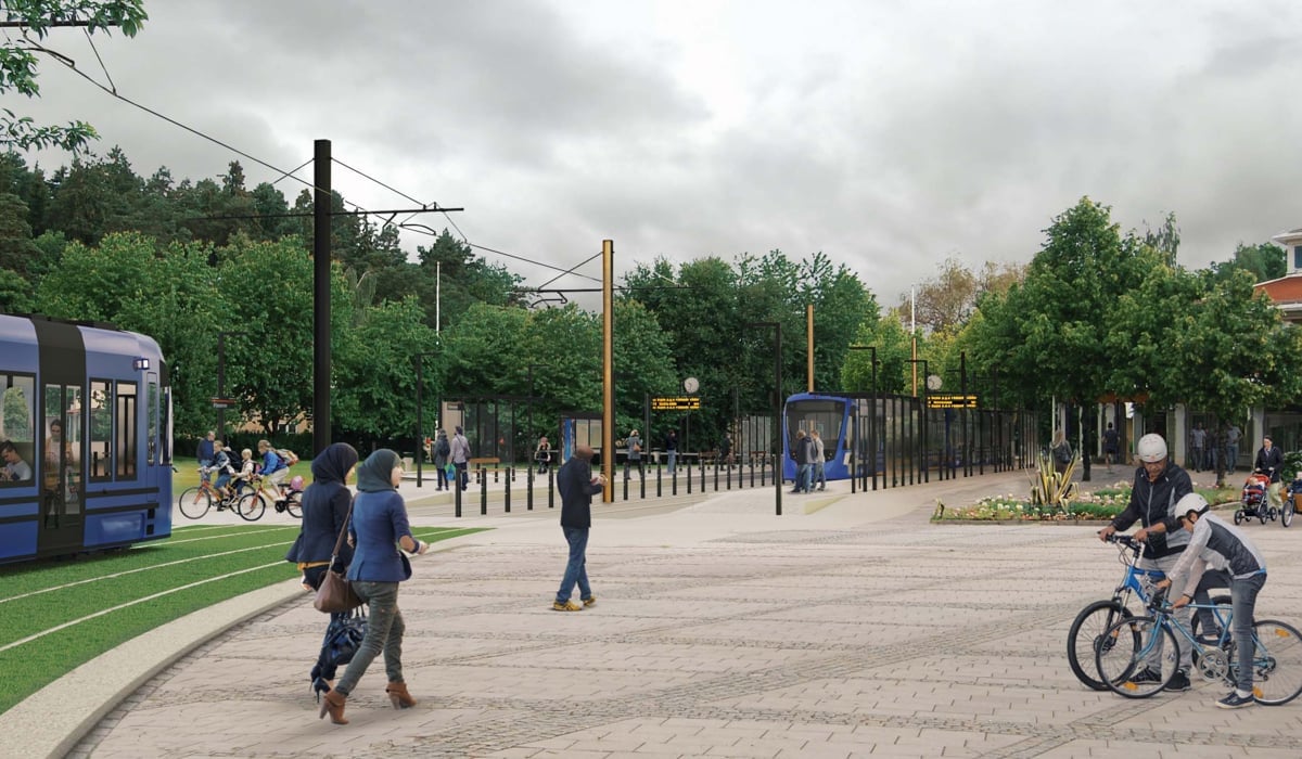 En grupp människor som går och cyklar i en park.