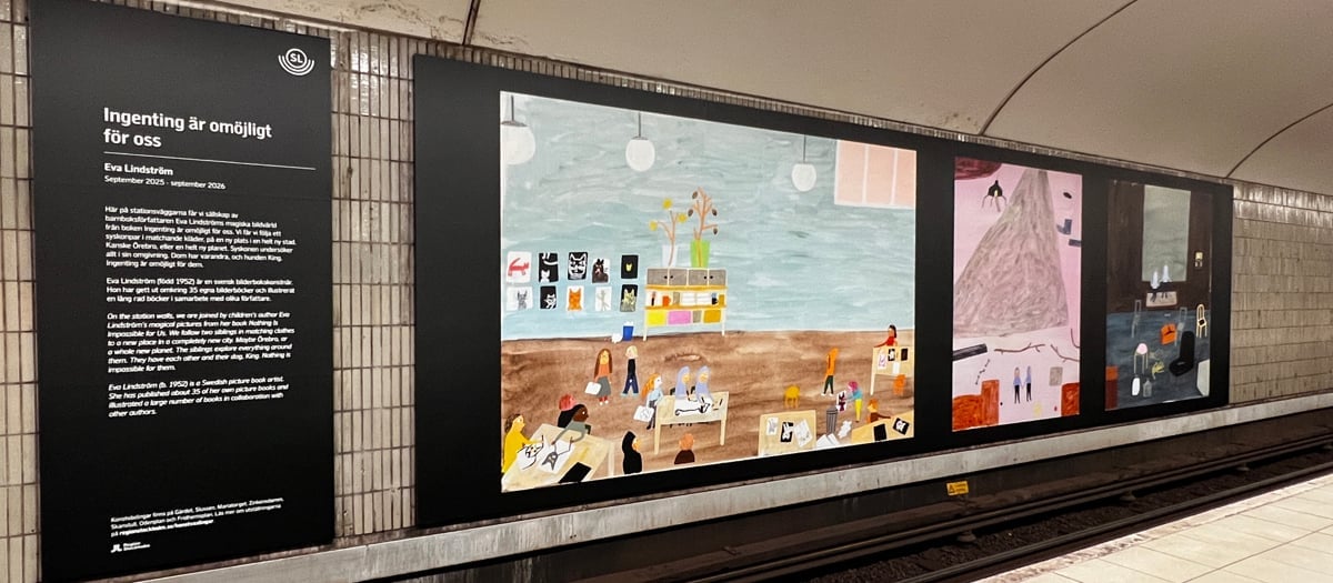 En tunnelbanestation med en stor affisch på väggen.