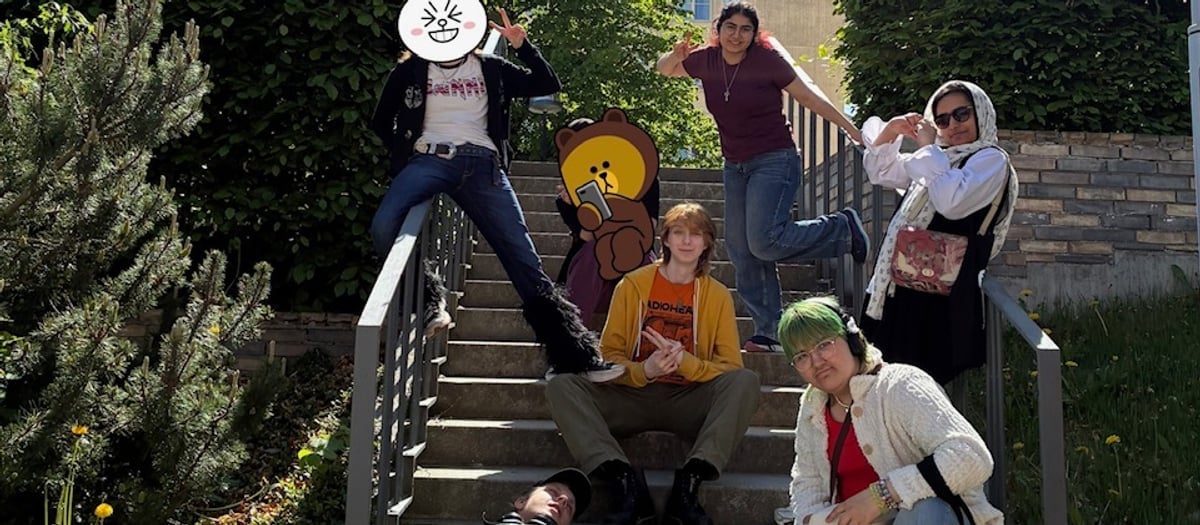En grupp med ungdomar som poserar i en trappa.