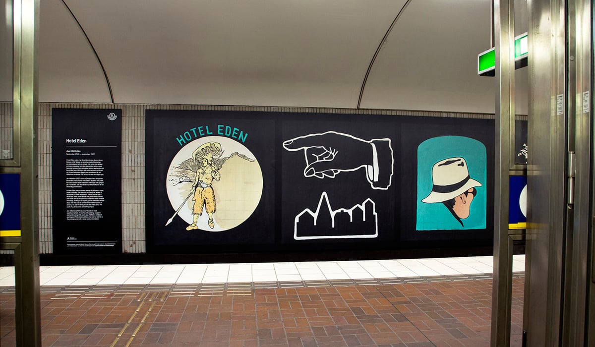 Lån bild utmed tunnelbanevägg med illustrationer.