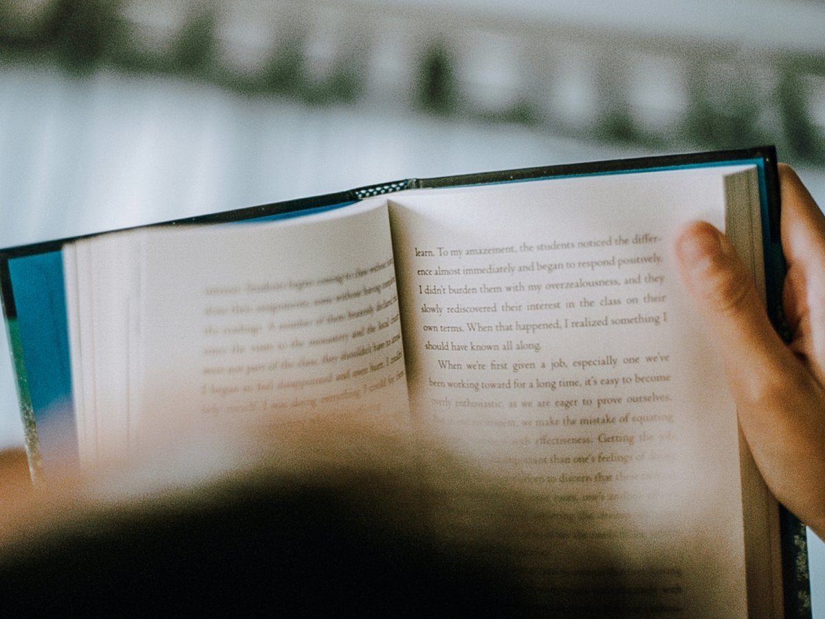 Närbild på en person som läser en bok